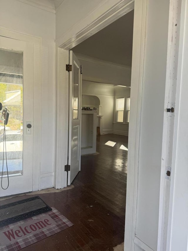 hallway with ornamental molding and dark hardwood / wood-style floors