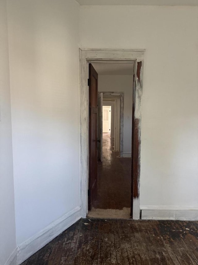 hallway with dark hardwood / wood-style flooring