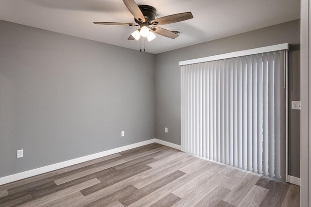 empty room featuring light wood-type flooring and ceiling fan