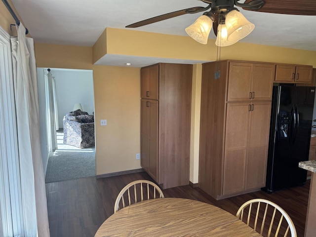 dining area with ceiling fan and dark hardwood / wood-style flooring