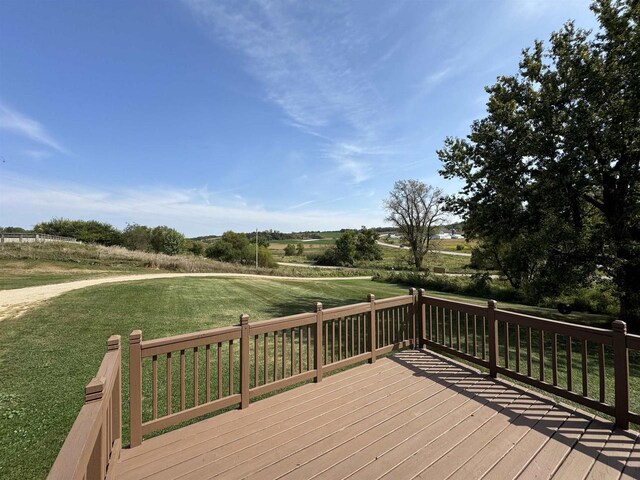 wooden deck featuring a lawn