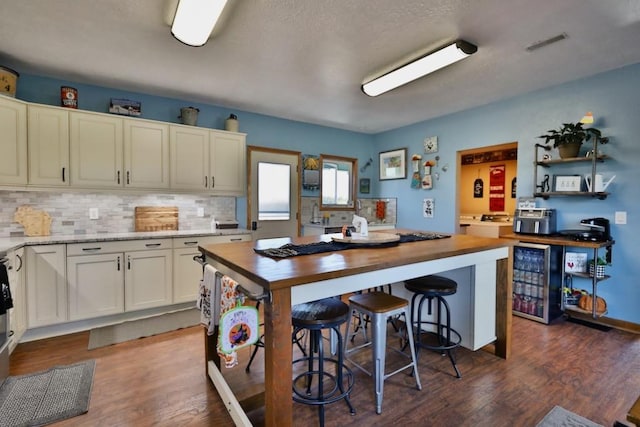 kitchen with white cabinets, beverage cooler, backsplash, dark hardwood / wood-style flooring, and wooden counters