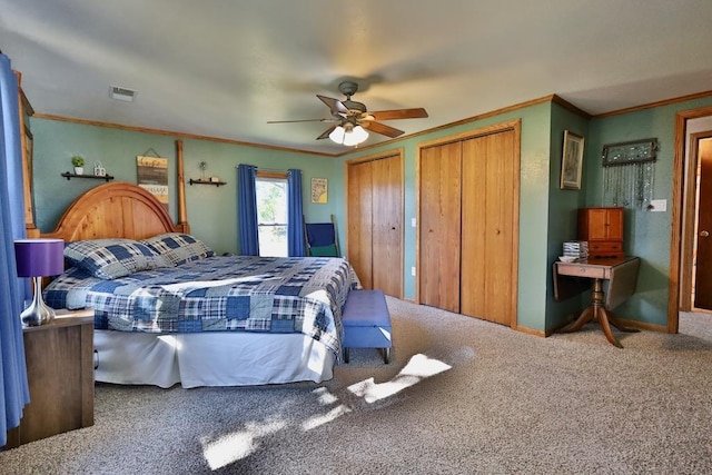 bedroom with crown molding, multiple closets, carpet flooring, and ceiling fan