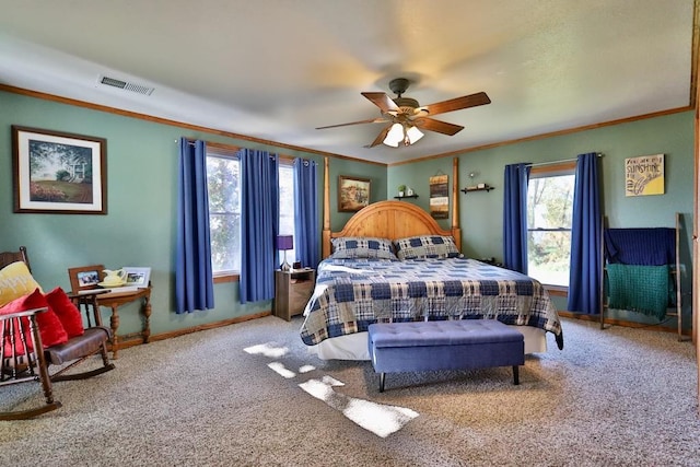 bedroom featuring ceiling fan, crown molding, and carpet flooring