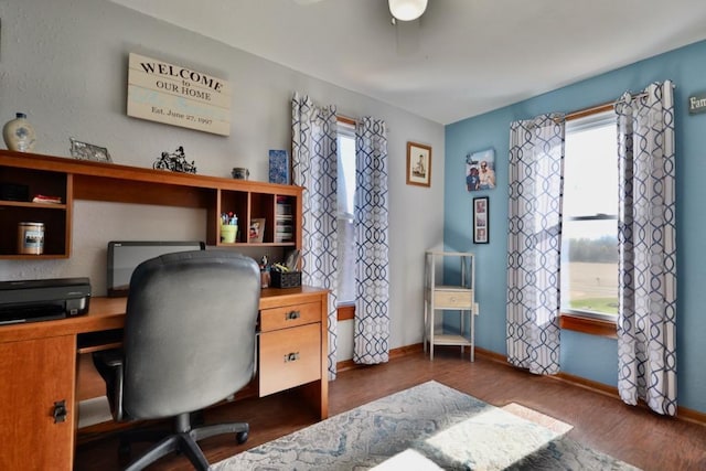 office space with dark wood-type flooring and ceiling fan