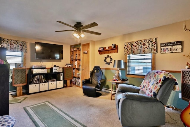 carpeted living room with a baseboard heating unit and ceiling fan