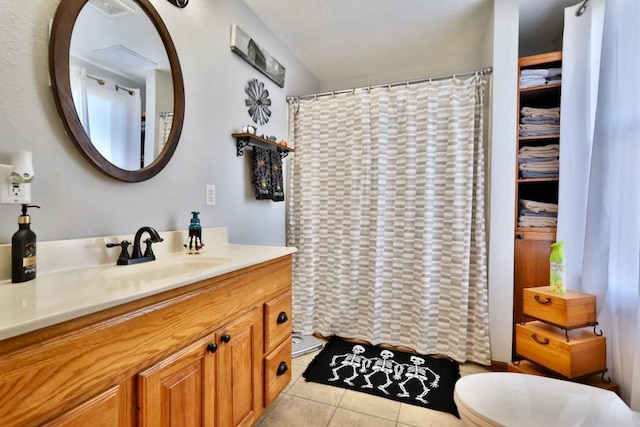 bathroom featuring vanity, toilet, a shower with shower curtain, and tile patterned flooring