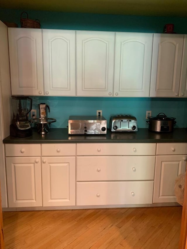 kitchen featuring white cabinetry and light hardwood / wood-style flooring