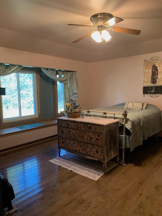 bedroom with ceiling fan and dark hardwood / wood-style flooring