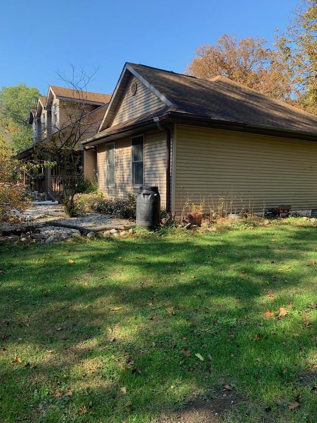 view of side of home with a lawn