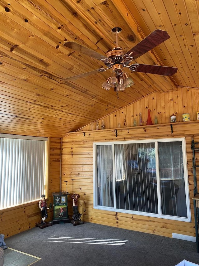 interior space with wooden walls, ceiling fan, carpet floors, and wooden ceiling