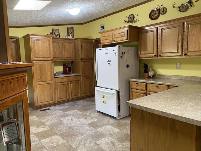 kitchen with ornamental molding, vaulted ceiling, a textured ceiling, and white refrigerator