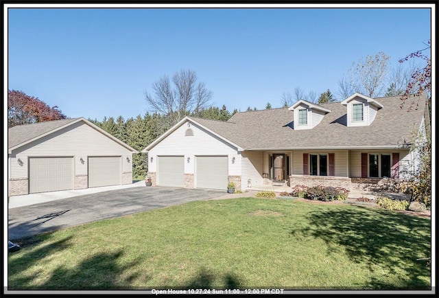 view of front of property featuring a front yard, a porch, and a garage