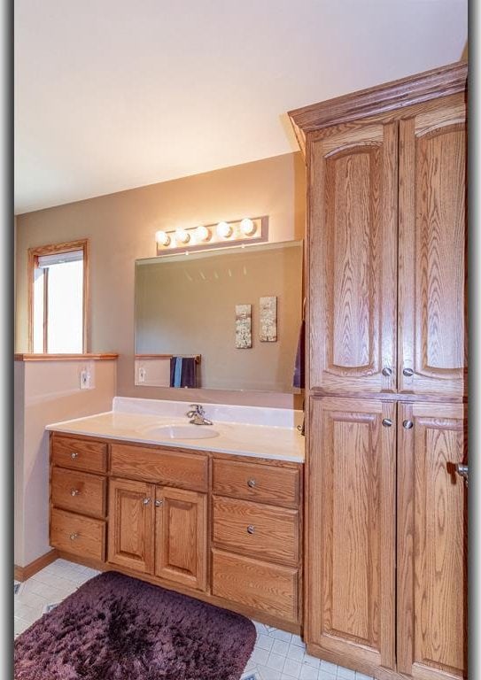 bathroom with vanity and tile patterned flooring