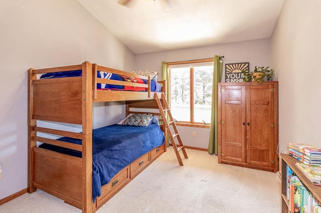 bedroom featuring light carpet, vaulted ceiling, and ceiling fan