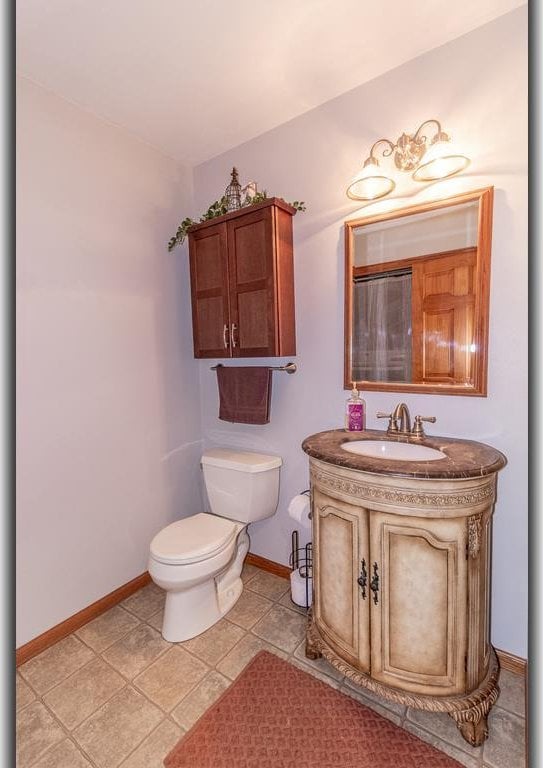 bathroom featuring vanity, toilet, and tile patterned floors