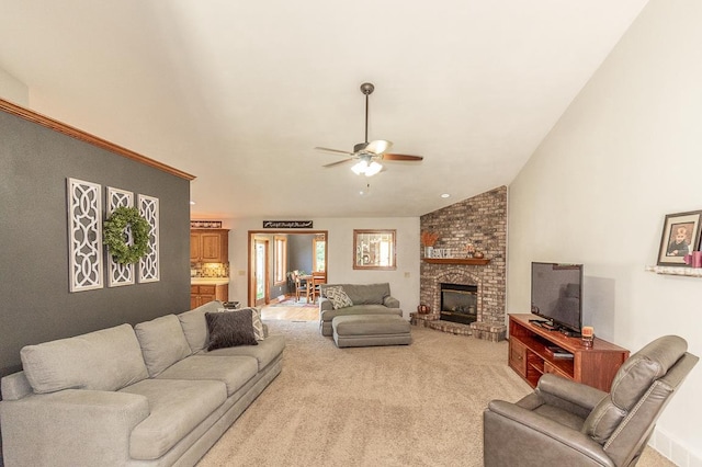 carpeted living room featuring lofted ceiling, a fireplace, and ceiling fan