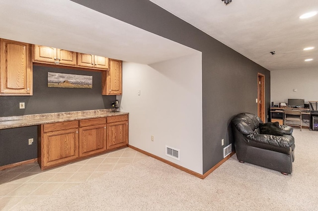 kitchen featuring light stone counters