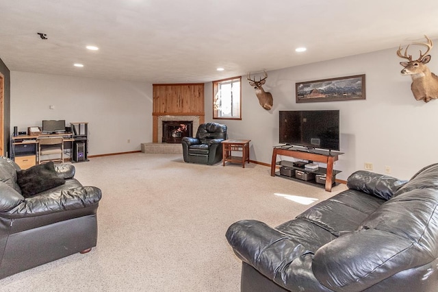 living room featuring a large fireplace and carpet flooring