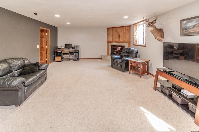 living room with light carpet and a large fireplace