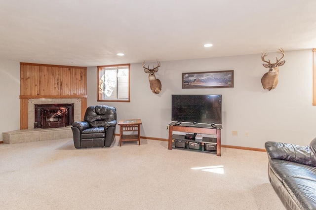 carpeted living room with a tiled fireplace