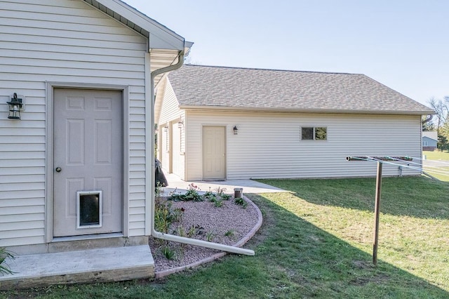 property entrance with a lawn