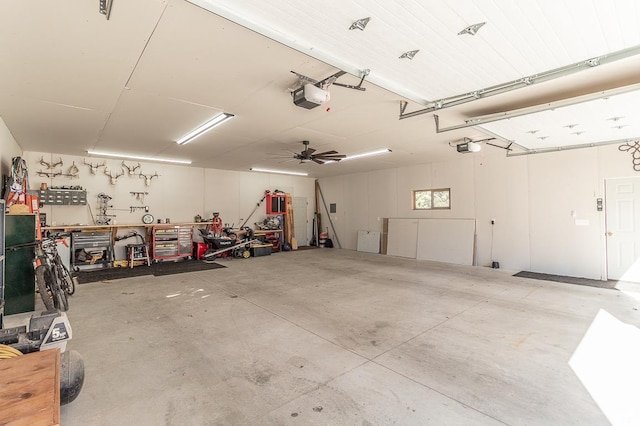 garage with a garage door opener, a workshop area, and ceiling fan