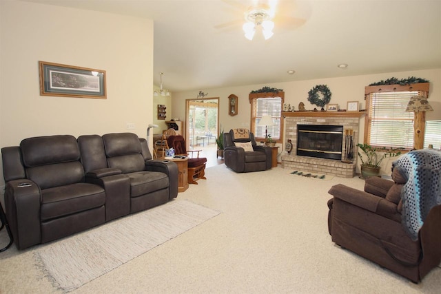 carpeted living room with lofted ceiling, a brick fireplace, and ceiling fan