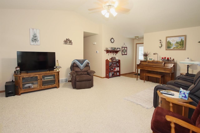 carpeted living room featuring ceiling fan and vaulted ceiling