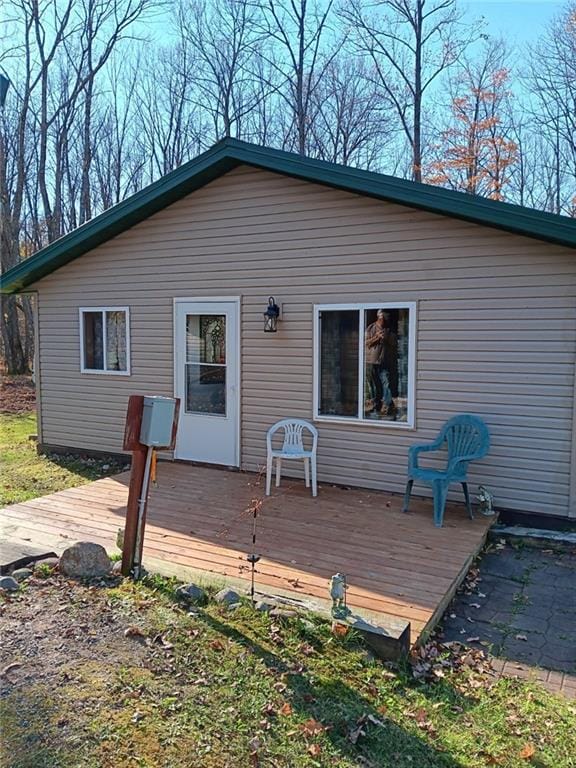 rear view of house featuring a deck