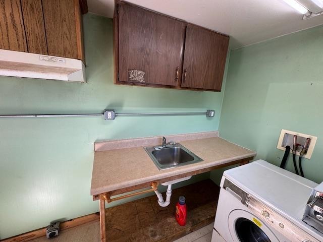 washroom featuring sink, cabinets, and washer / clothes dryer