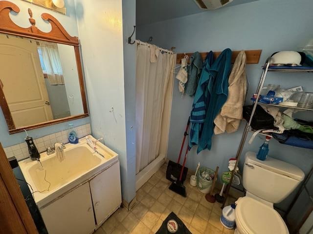 bathroom featuring vanity, decorative backsplash, a shower with curtain, and toilet