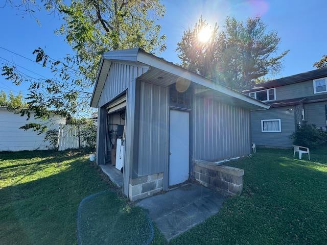 view of outbuilding with a yard and a garage