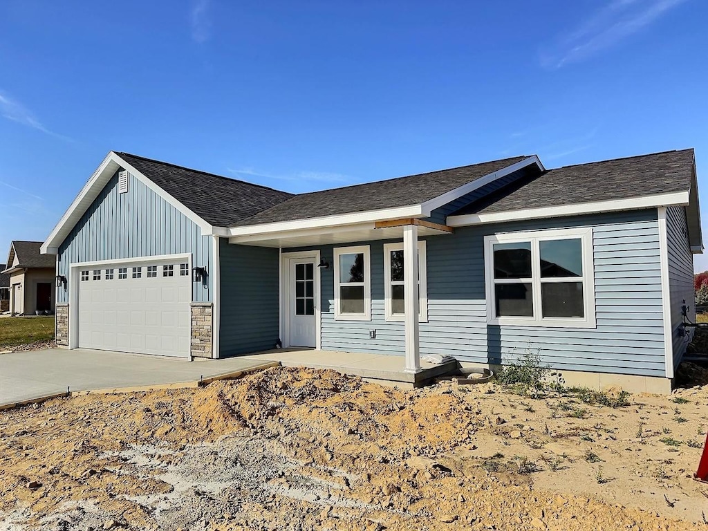 ranch-style house featuring a garage and covered porch