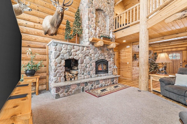 living room with log walls, wood ceiling, a fireplace, and wood-type flooring