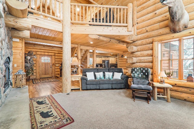 living room featuring a stone fireplace, hardwood / wood-style flooring, wooden ceiling, and rustic walls