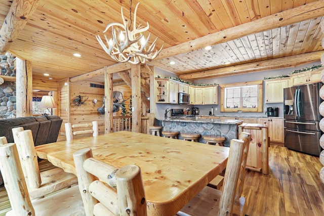 dining room featuring wood ceiling, beam ceiling, light hardwood / wood-style flooring, and a chandelier