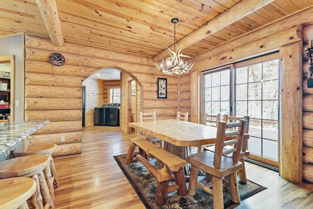 dining area with beam ceiling, wooden ceiling, and light hardwood / wood-style flooring