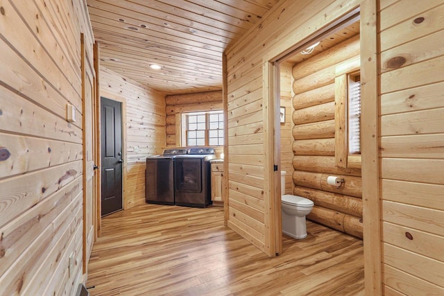 bathroom with washing machine and dryer, wood ceiling, hardwood / wood-style flooring, and toilet