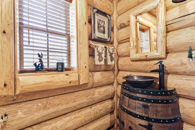 bathroom featuring log walls