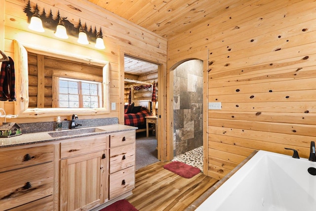 bathroom featuring wood ceiling, hardwood / wood-style floors, wooden walls, vanity, and plus walk in shower