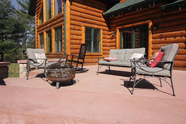 view of patio featuring an outdoor living space with a fire pit