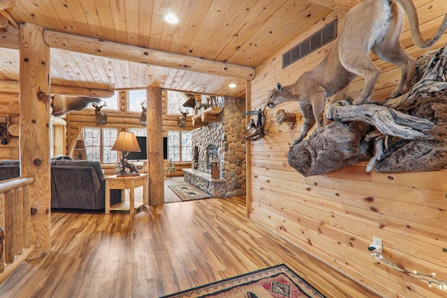 living room with beamed ceiling, hardwood / wood-style floors, and wood ceiling