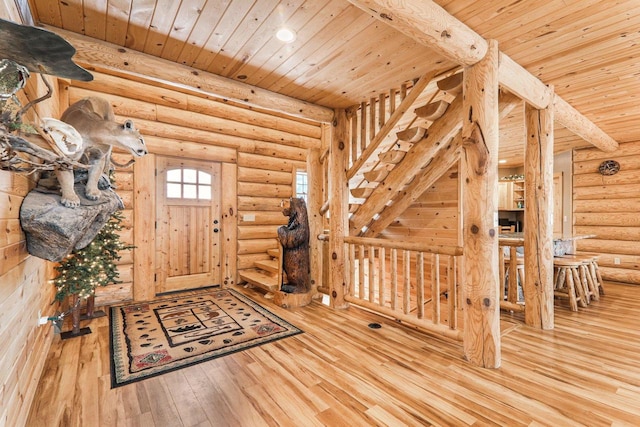 foyer entrance with wood ceiling, hardwood / wood-style flooring, and log walls