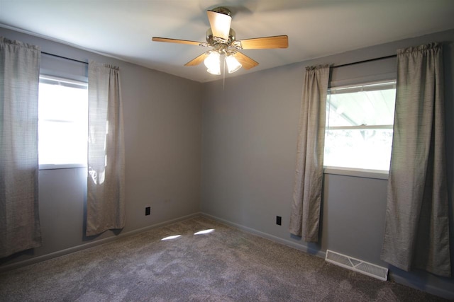 spare room with carpet, ceiling fan, and plenty of natural light