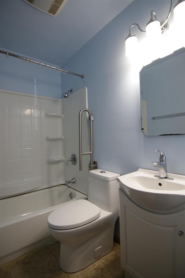 full bathroom with tiled shower / bath, vanity, toilet, and tile patterned floors