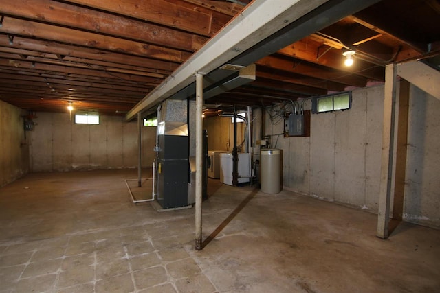 basement with washing machine and dryer, electric panel, and heating unit