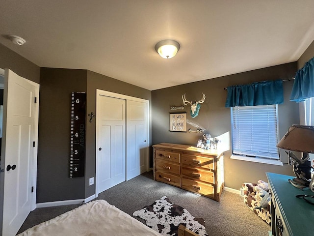 bedroom featuring dark carpet and a closet