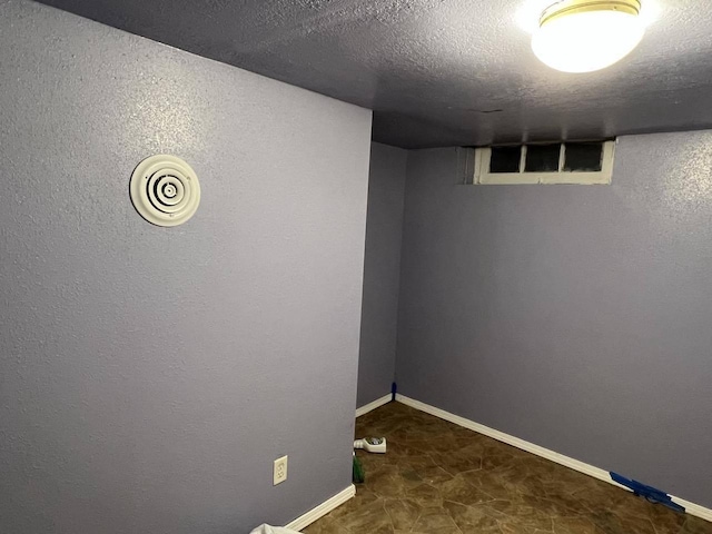 basement with a textured ceiling