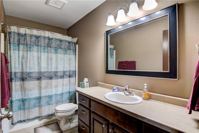 bathroom with vanity, a shower with shower curtain, and toilet